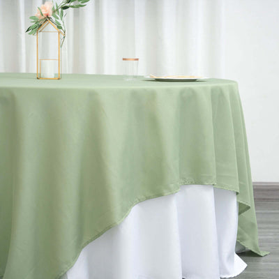 Green tablecloth draping elegantly over a white table.