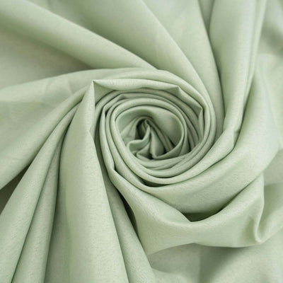 Light green fabric rolled in a spiral formation.