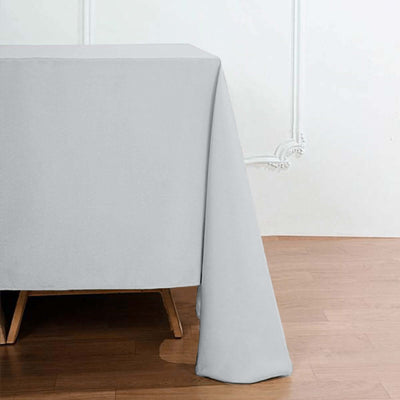 Gray tablecloth draping elegantly over a wooden table.