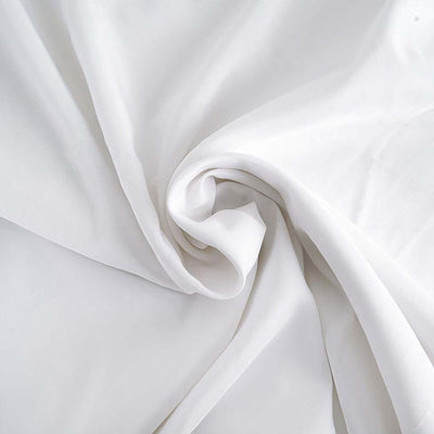 Smooth white fabric draped in elegant folds.