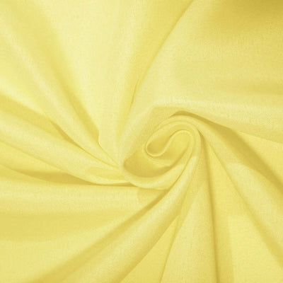 Close-up of soft yellow fabric with a smooth texture.