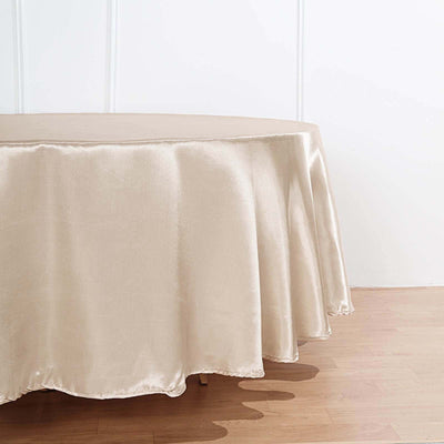 Beige satin tablecloth draped elegantly on a round table.