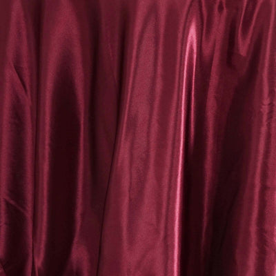 Burgundy satin fabric draped elegantly, showcasing its smooth texture.
