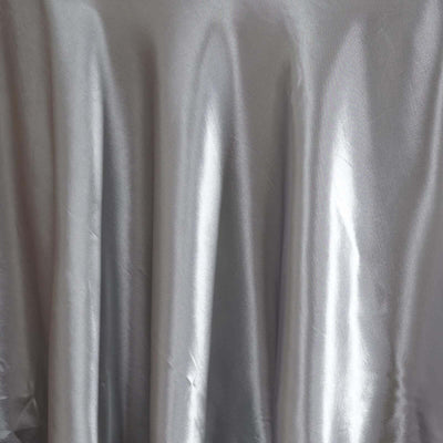 Silver satin fabric draped elegantly, showcasing its smooth texture and sheen.