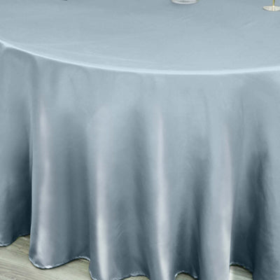 Silver satin tablecloth draping elegantly over a round table.