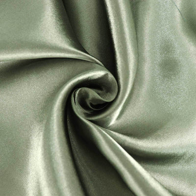 Green satin fabric swirl texture close-up shot.