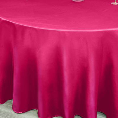 Fuchsia satin tablecloth draped elegantly over a round table.