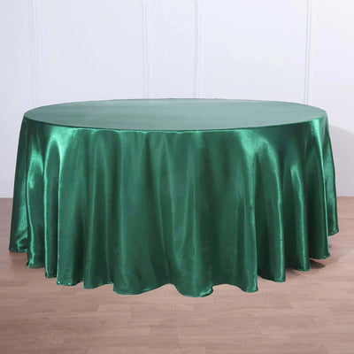 Round green satin tablecloth on a plain background.