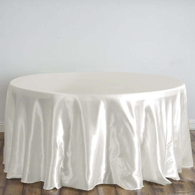 Round silk tablecloth in soft white against a plain backdrop.