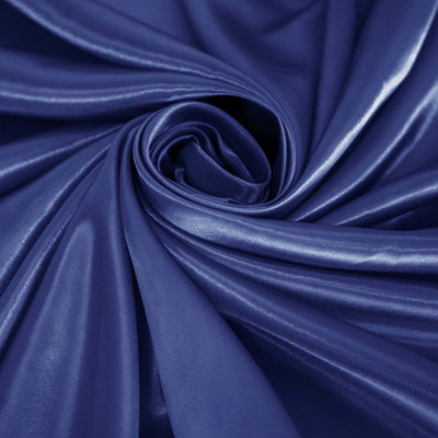 Shiny deep blue fabric in a swirling pattern.