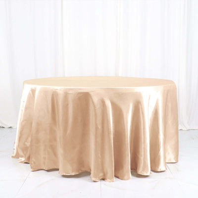 Round satin tablecloth in beige color, elegantly draped.