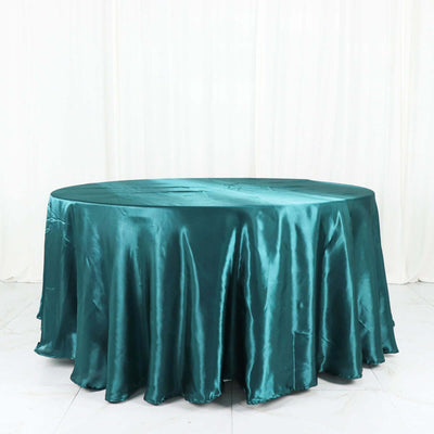 Teal satin tablecloth draped elegantly on a round table