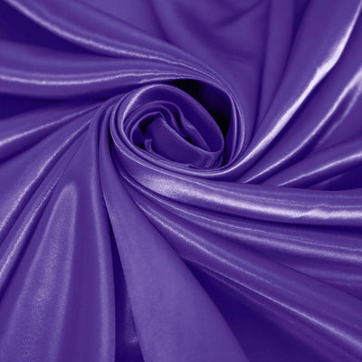 Shiny purple fabric elegantly draped in a spiral pattern.