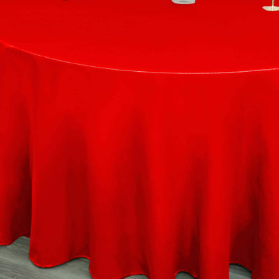 Red tablecloth draped elegantly over a round table.