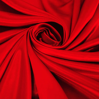 Red satin fabric draped in elegant folds, showcasing its rich texture and sheen.