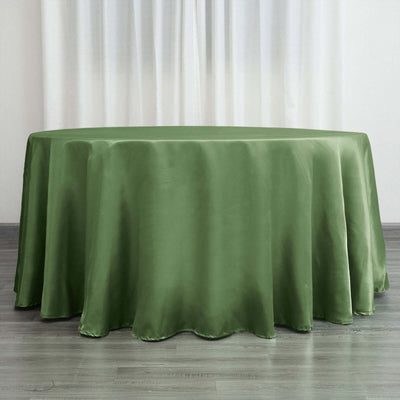 Green satin tablecloth draped over a round table.