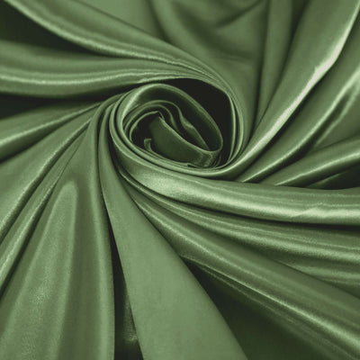 Green satin fabric in a swirling pattern showcasing its smooth texture.
