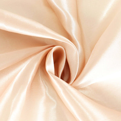 Soft peach satin fabric with smooth texture and elegant drape.