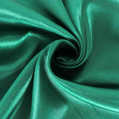Shiny emerald green satin fabric with smooth texture.