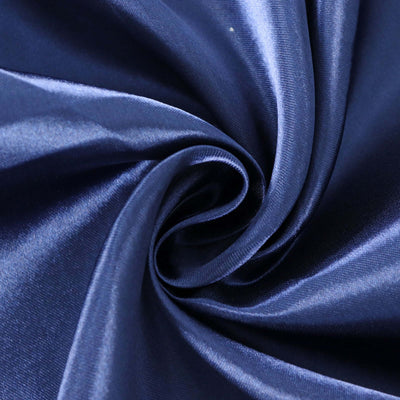 Navy satin fabric swirl showing smooth texture and sheen.