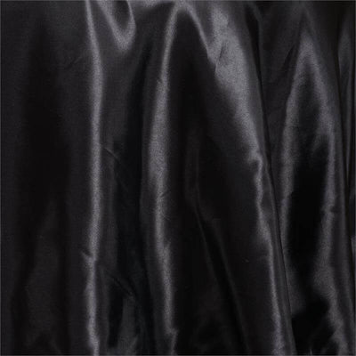 Black silky fabric draped with soft folds.