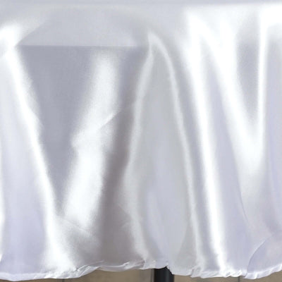 Shiny white satin fabric draped elegantly on a surface.