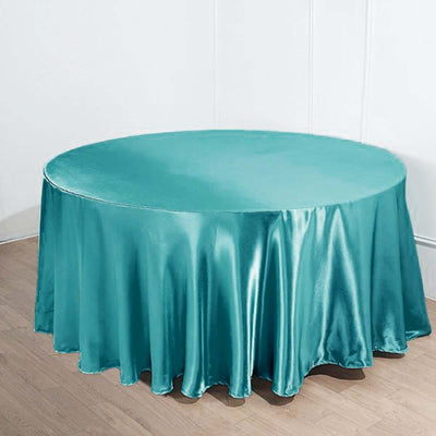 Teal satin tablecloth draped over a round table.