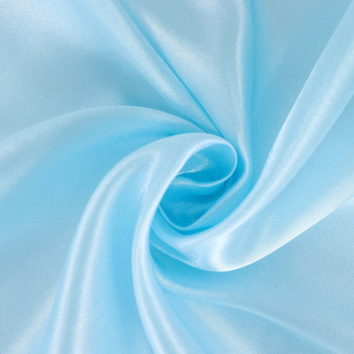 Light blue satin fabric swirl texture close-up.