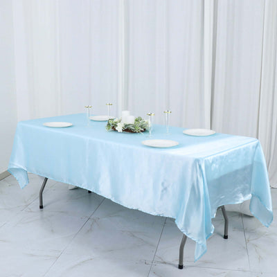 Light blue satin tablecloth draped over a table with decorative accents.