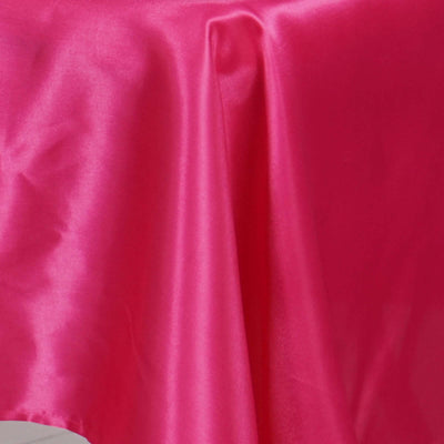 Shiny pink satin fabric draped elegantly.