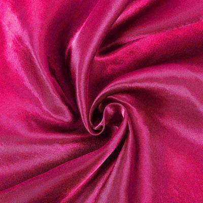 Vibrant fuchsia satin fabric swirling texture close-up.