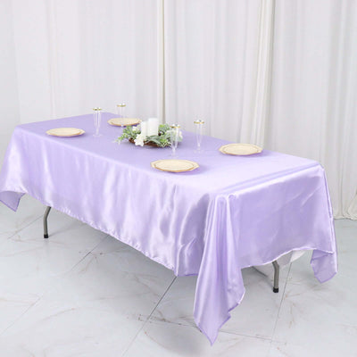 Lavender satin tablecloth draped over a table with elegant dinnerware.
