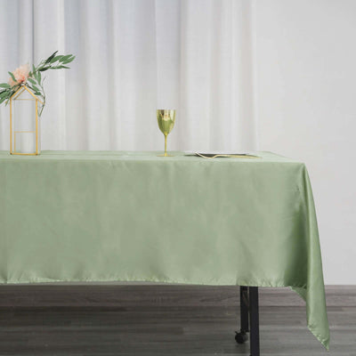 Green satin tablecloth draped elegantly on a table with decorative elements.