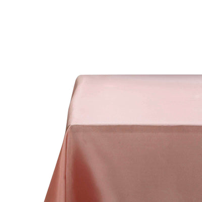 Soft pink tablecloth draped elegantly over a table edge.
