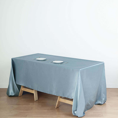 Elegant gray tablecloth draped over a wooden table with plates