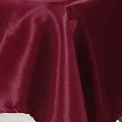Burgundy satin fabric draping elegantly on a table