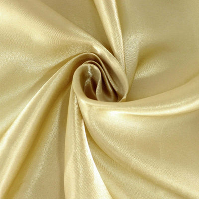 Gold satin fabric in a smooth, elegant swirl.