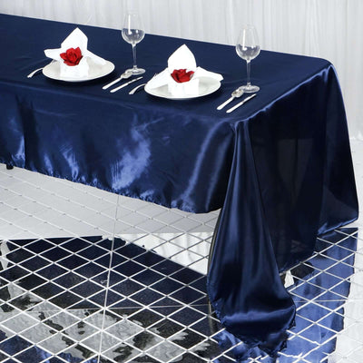 Elegant navy satin tablecloth set for a formal dining experience.
