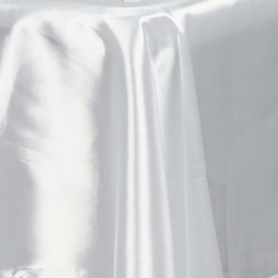 White satin fabric draped elegantly, showcasing its smooth texture.