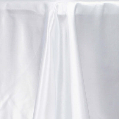White satin fabric draped elegantly on a table