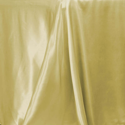 Golden satin fabric draped elegantly on a surface.