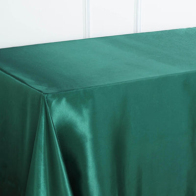 Green satin tablecloth on a plain background