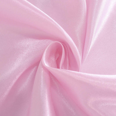 Soft pink satin fabric close-up texture.