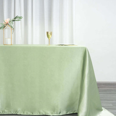 Elegant green tablecloth draped over a table in a softly lit setting.