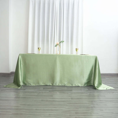 Elegant green tablecloth draped over a table in a bright, minimalistic setting.