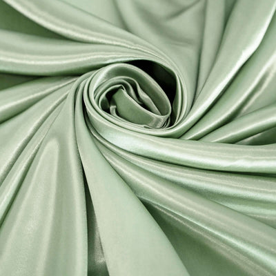 Soft green satin fabric in a swirling pattern.