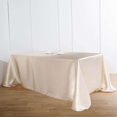 Cream satin tablecloth draped elegantly over a table.