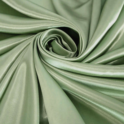 Soft green satin fabric draped in elegant folds.