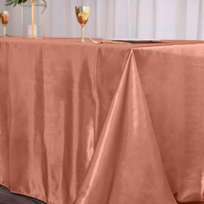 Elegant rose gold tablecloth draping over a table for events or dining.