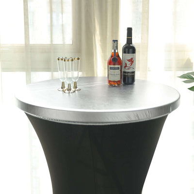Elegant black and silver cocktail table with drinks and glasses.